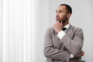 Photo of Portrait of confident young man in office, space for text. Lawyer, businessman, accountant or manager