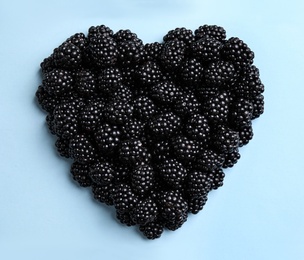 Photo of Flat lay composition with ripe blackberries on light blue background