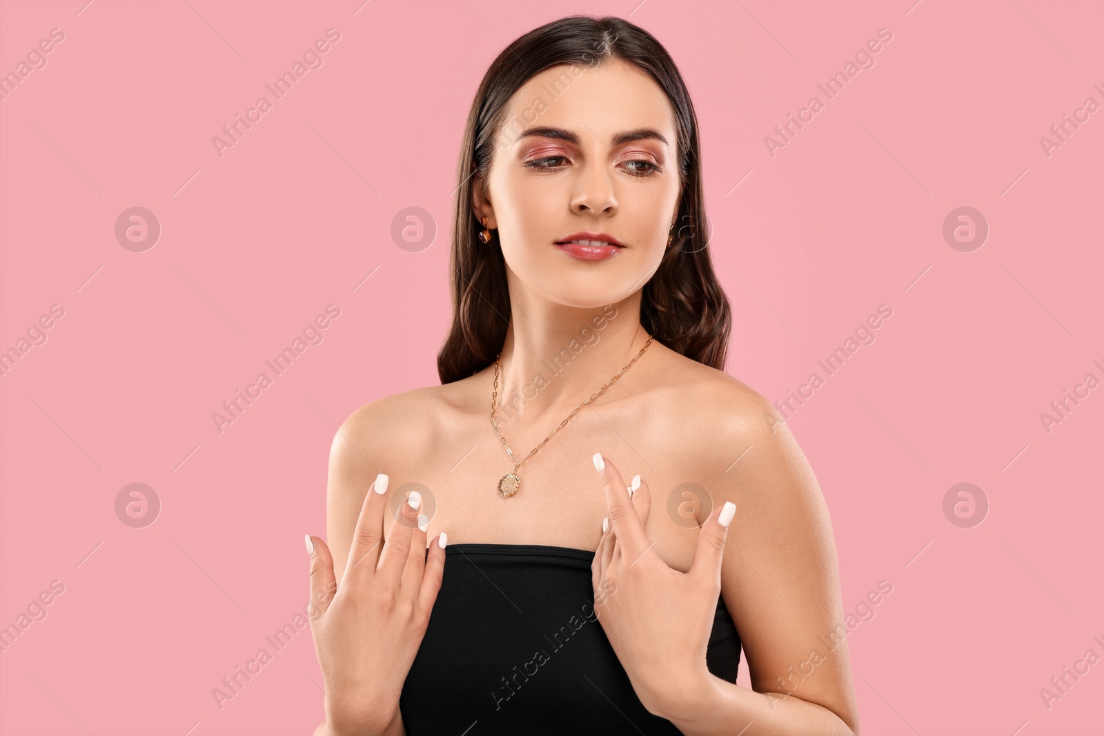 Photo of Beautiful woman with elegant necklace on pink background