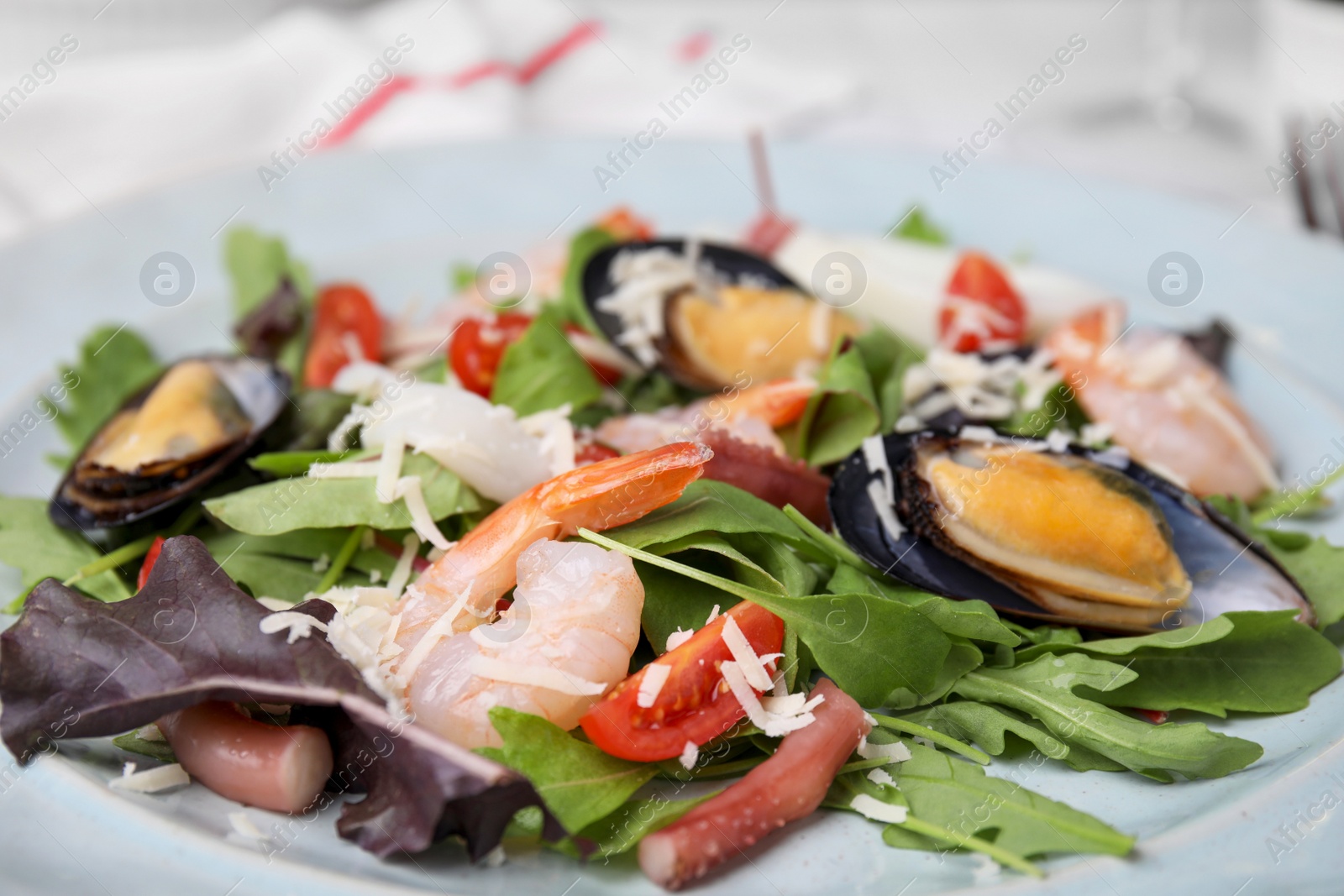 Photo of Plate of delicious salad with seafood, closeup view