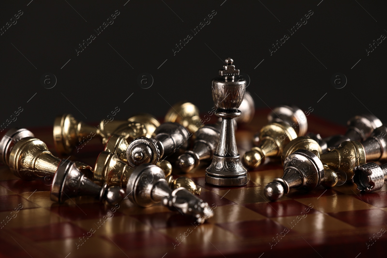 Photo of Chessboard with game pieces on black background