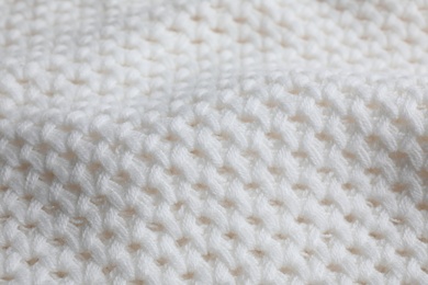 Photo of White knitted sweater as background, closeup view