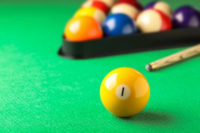 Billiard ball with number 1 on green table, space for text