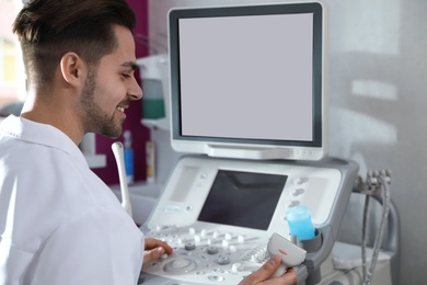 Photo of Sonographer using modern ultrasound machine in clinic