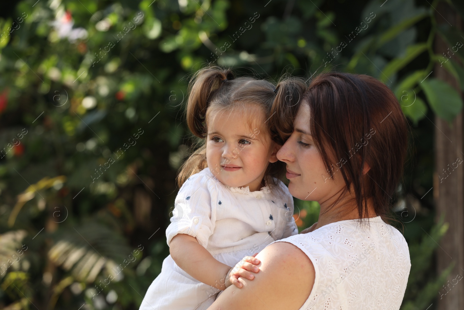 Photo of Portrait of mother with her cute daughter outdoors