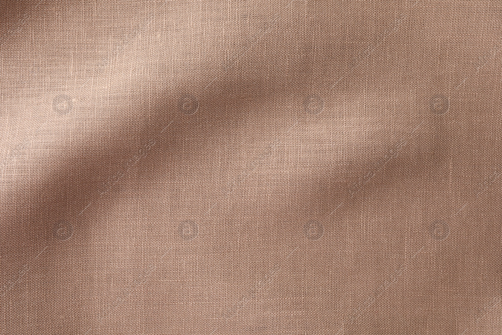 Photo of Texture of brown crumpled fabric as background, top view