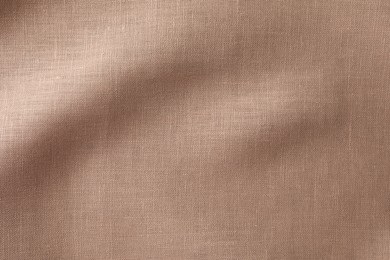 Texture of brown crumpled fabric as background, top view