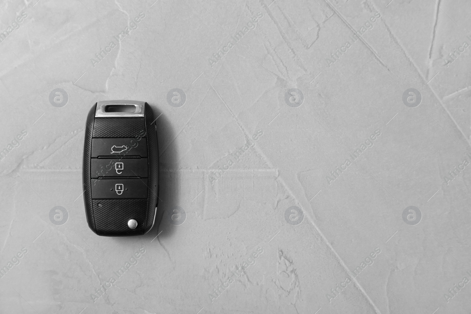 Photo of Remote car key on grey background, top view. Space for text