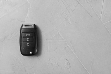 Photo of Remote car key on grey background, top view. Space for text