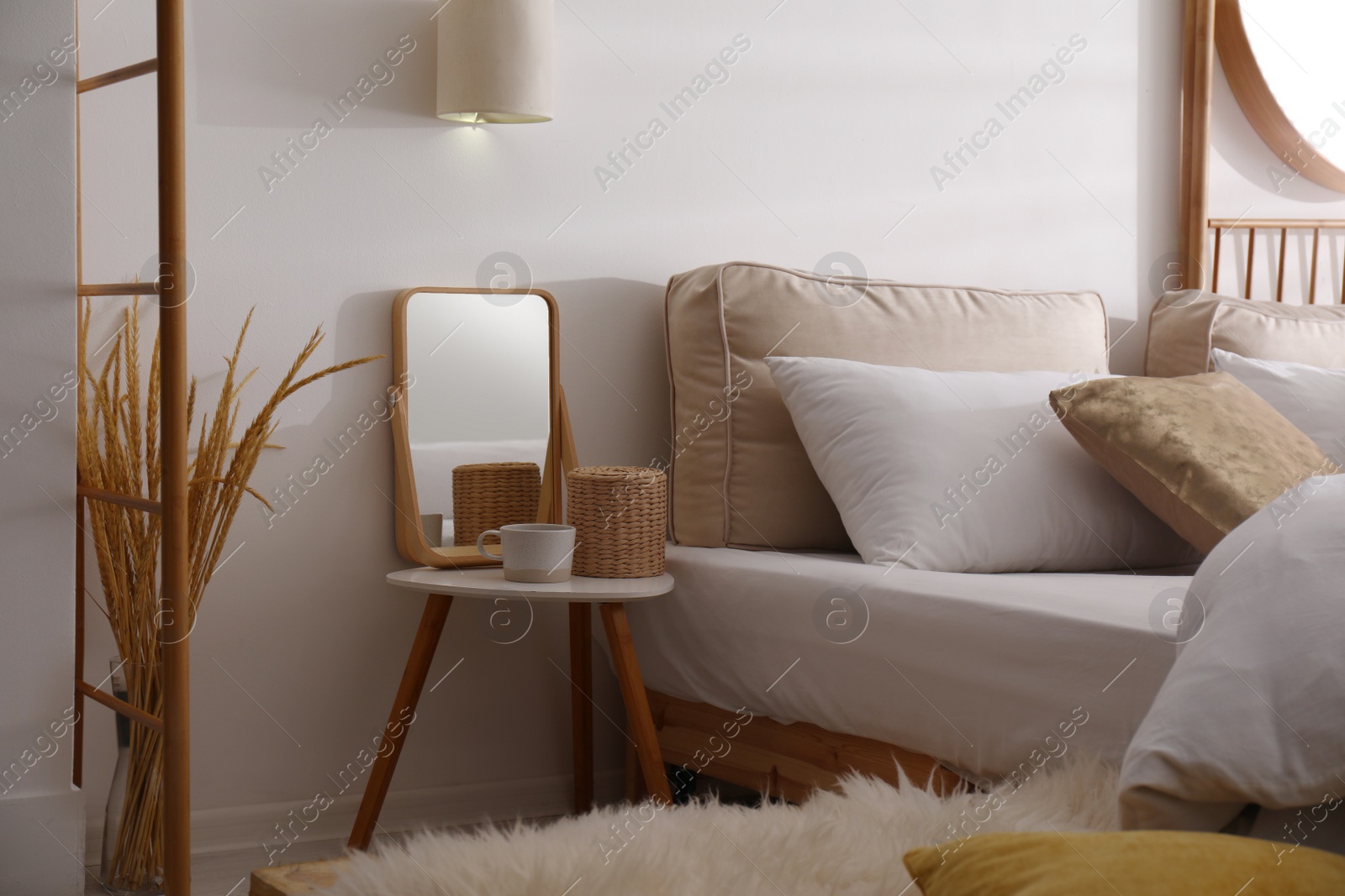 Photo of Stylish nightstand near bed in modern room interior
