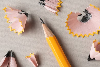 Photo of Graphite pencil and shavings on grey background, top view. Macro photo