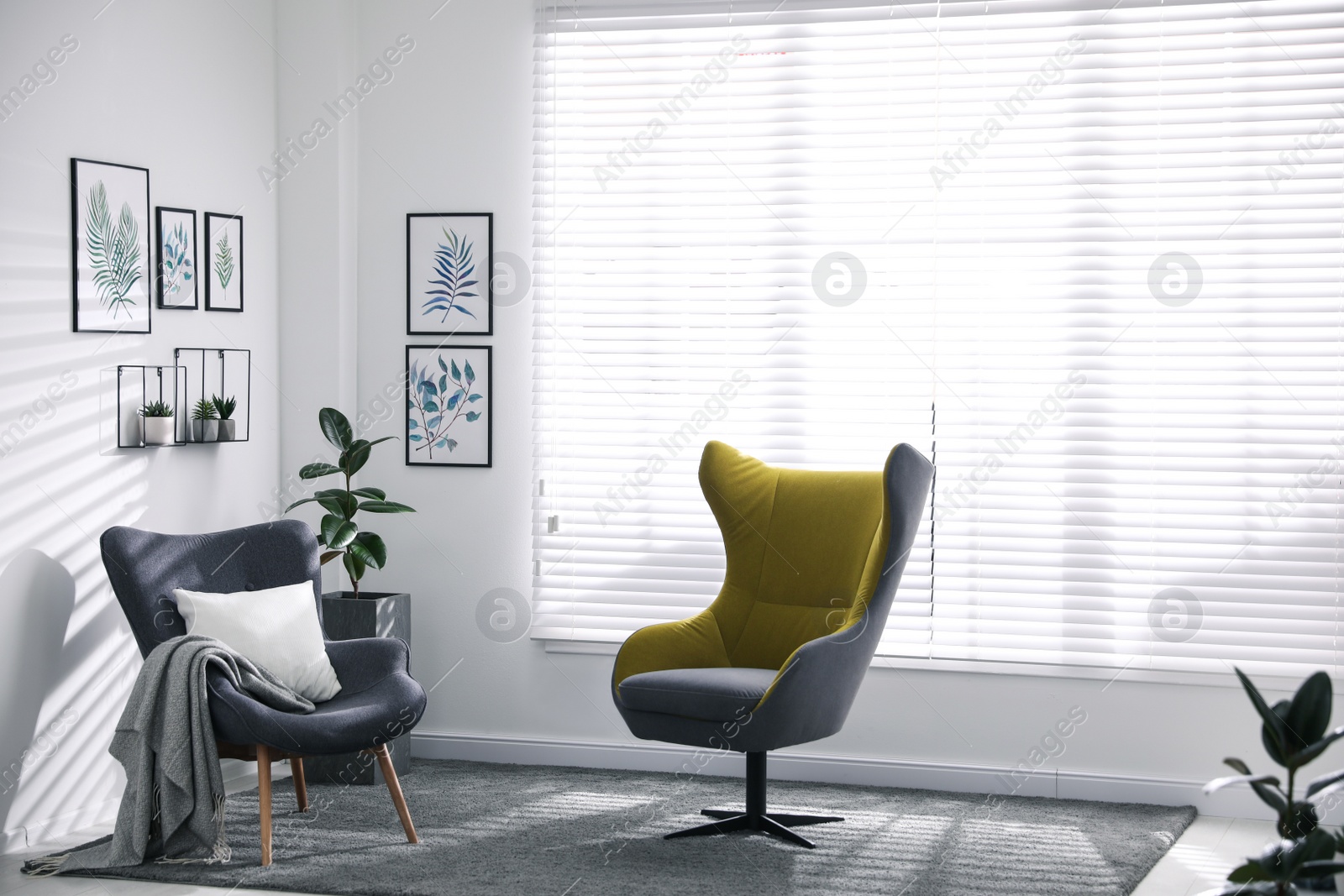 Photo of Comfortable armchairs near window in light room