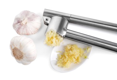 Photo of One metal press and garlic isolated on white, top view
