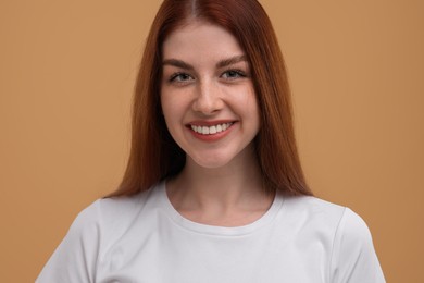 Photo of Portrait of smiling woman with freckles on beige background