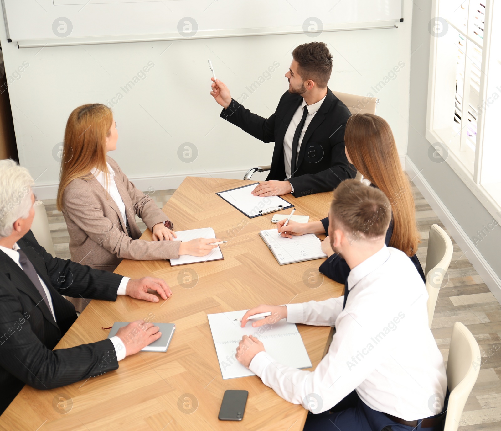 Photo of Professional business trainer working with people in office