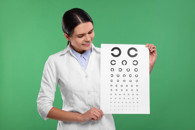 Ophthalmologist with vision test chart on green background