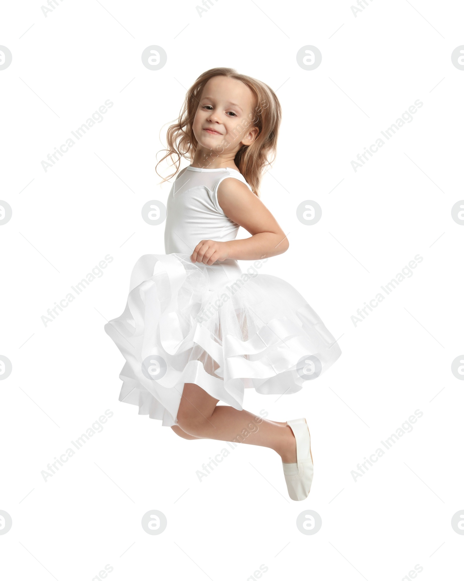 Photo of Cute little dancer in beautiful dress jumping on white background