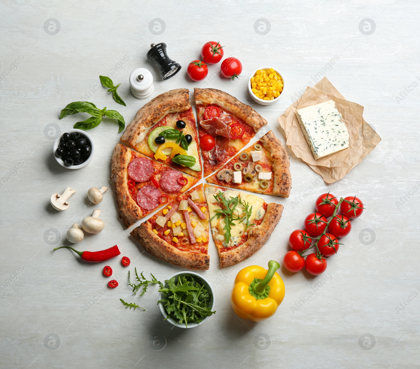 Photo of Flat lay composition with slices of different delicious pizzas on light grey table
