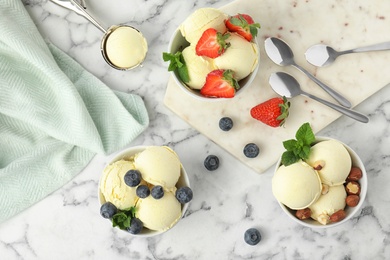Flat lay composition with delicious vanilla ice cream on marble table