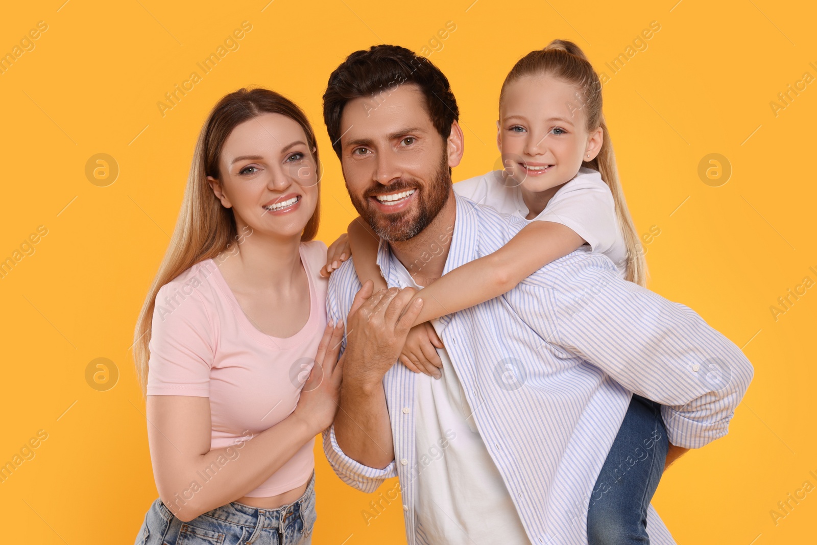 Photo of Portrait of happy family on orange background