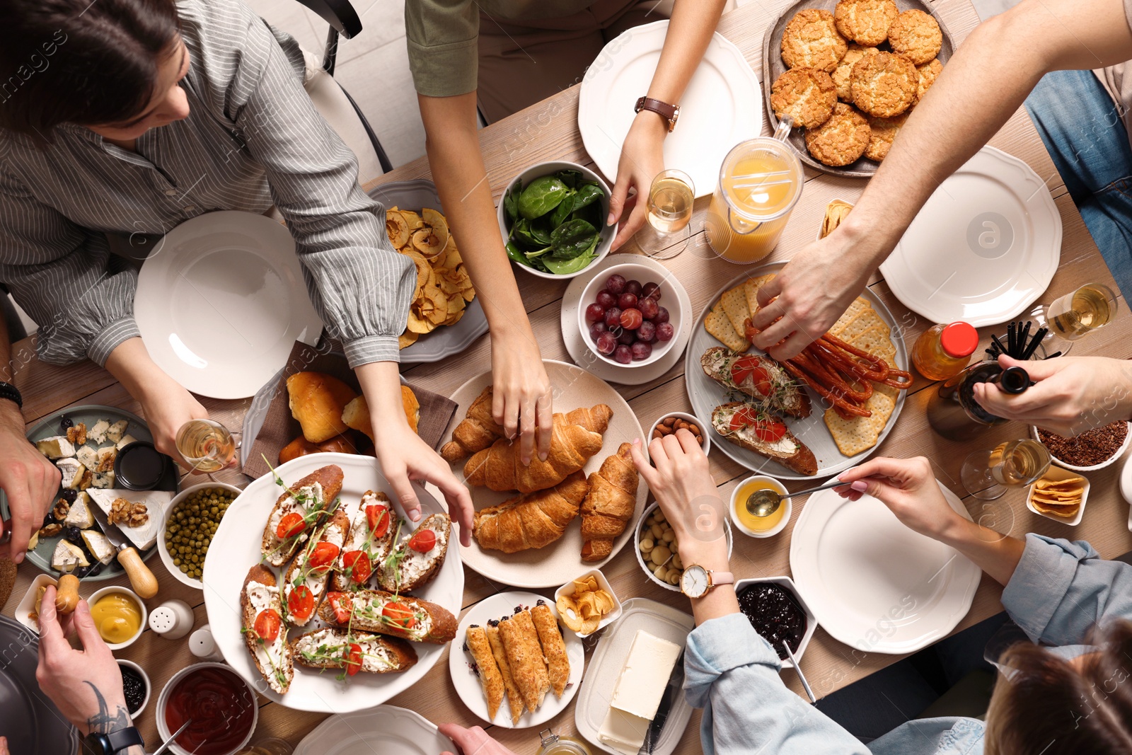 Photo of Group of people having brunch together at table, top view