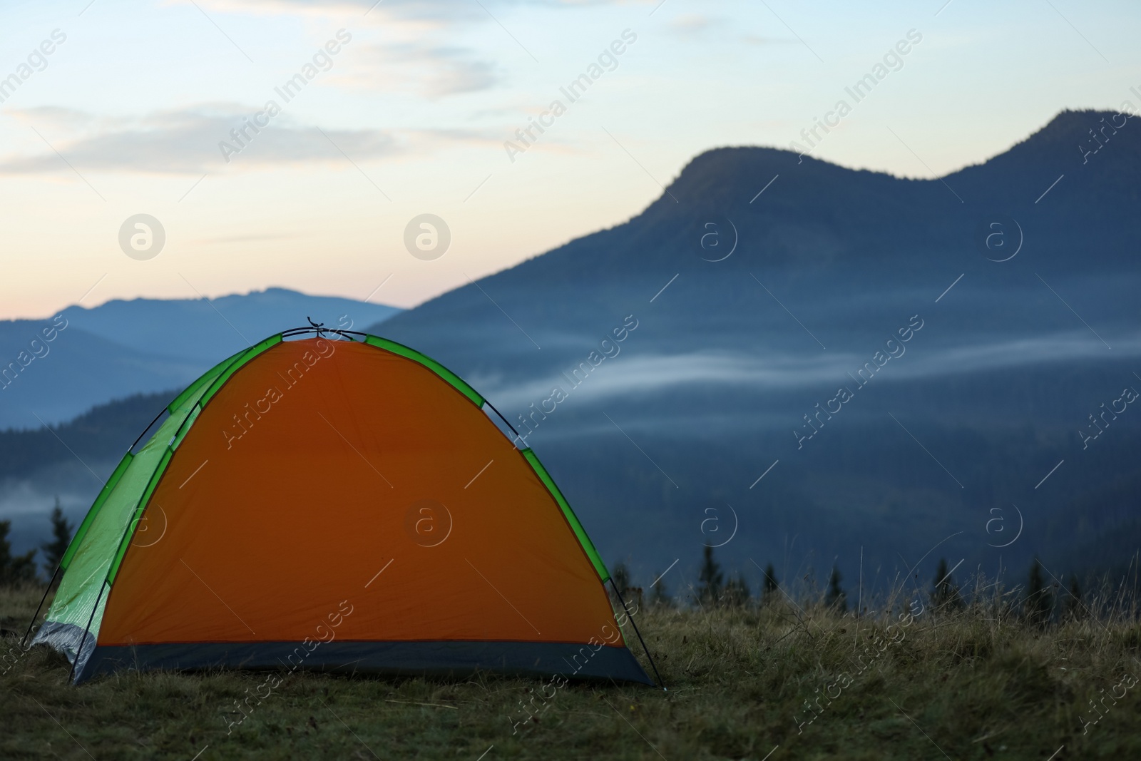 Photo of Camping tent in mountains on early morning