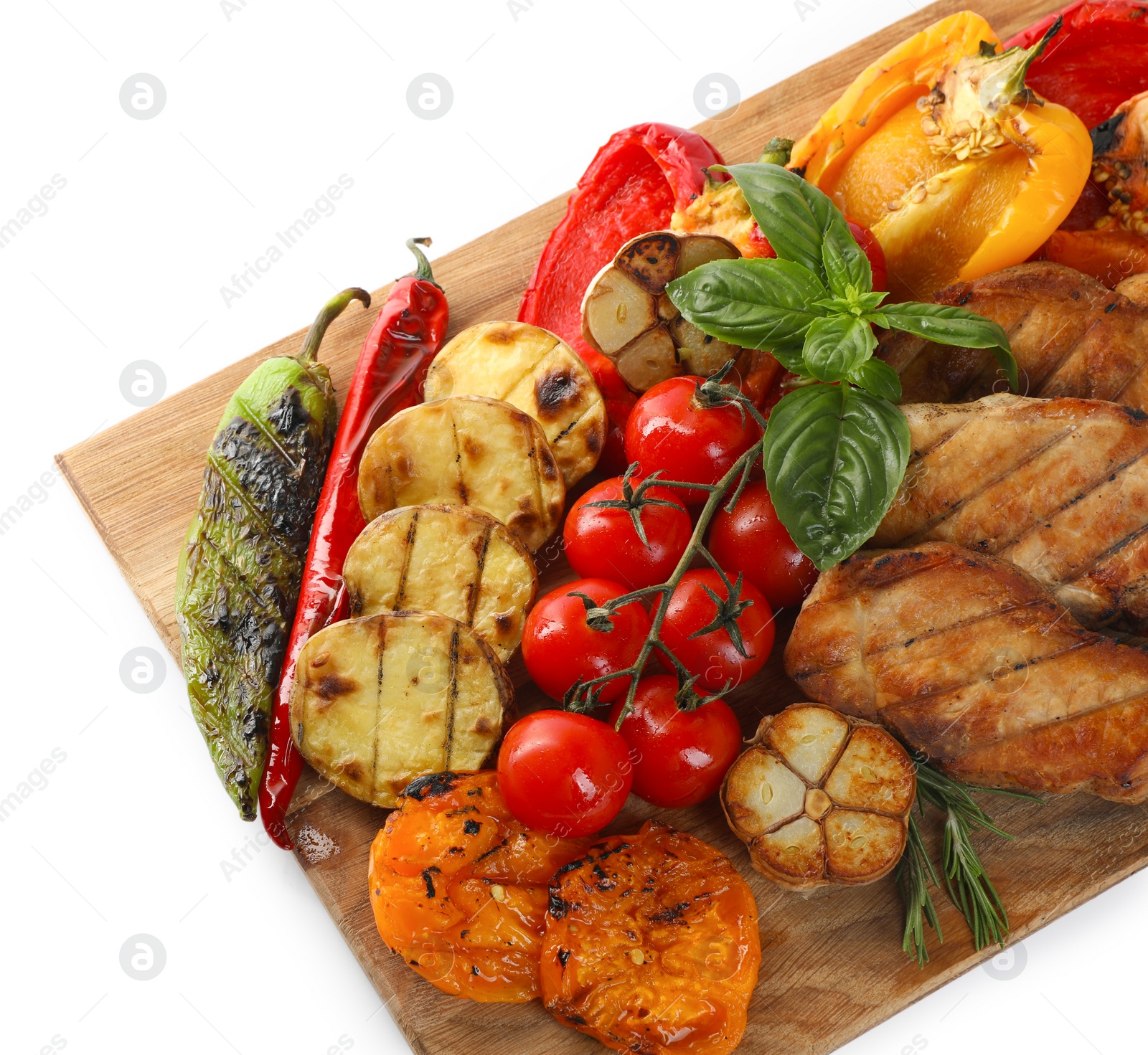 Photo of Wooden board with tasty grilled vegetables, meat, rosemary and basil isolated on white, top view