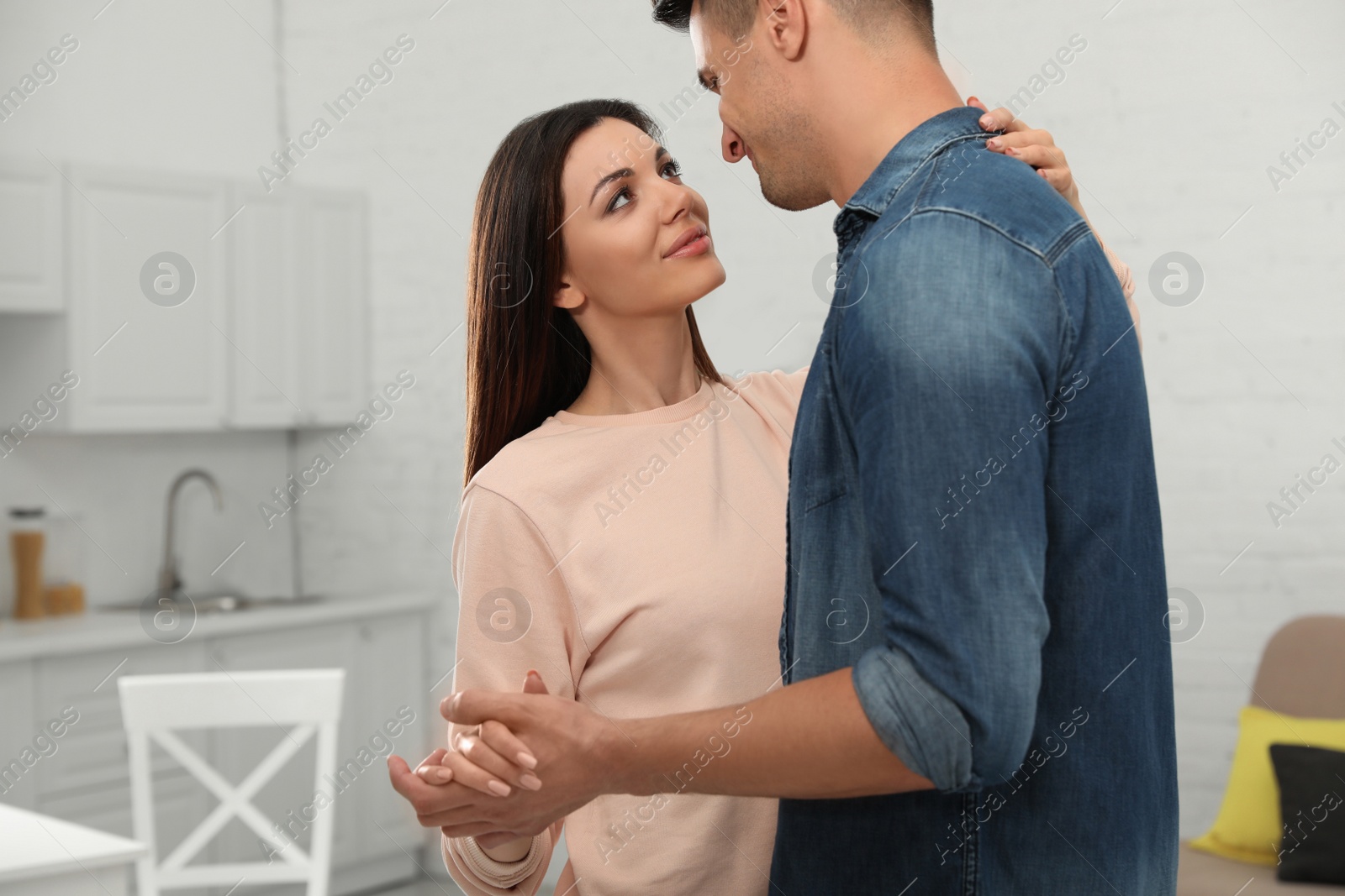 Photo of Happy couple dancing in kitchen at home