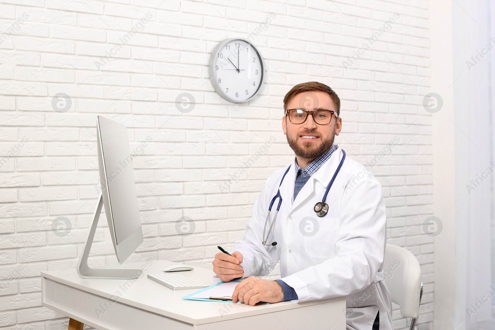 Photo of Portrait of pediatrician at table in clinic