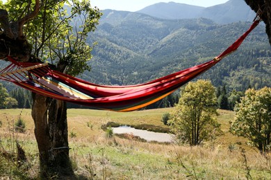 Photo of Empty comfortable hammock in mountains on sunny day