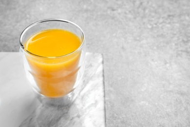 Glass of orange juice on table