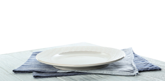 Photo of Empty plate and napkin on wooden table against white background