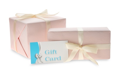Photo of Gift card and presents on white background