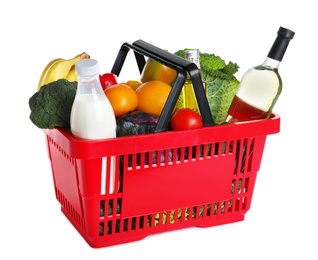 Shopping basket with grocery products on white background