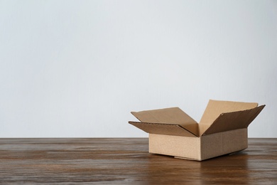 Photo of Cardboard box on wooden table