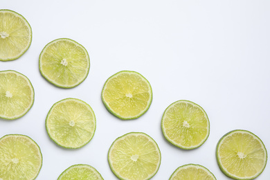 Fresh juicy lime slices on white background, top view