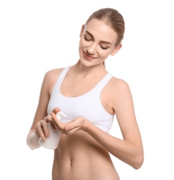 Young woman with bottle of body cream on white background