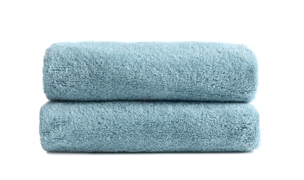 Folded clean soft towels on white background