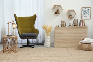 Photo of Stylish living room interior with comfortable armchair and wooden table