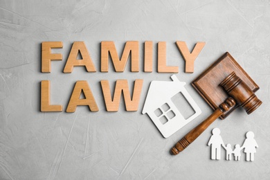 Photo of Flat lay composition with words FAMILY LAW on grey background