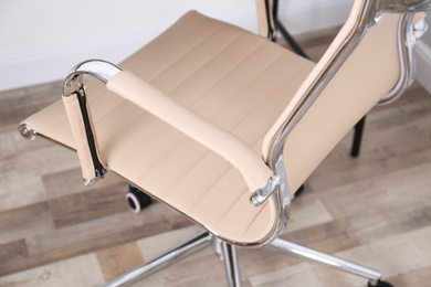Photo of Modern comfortable office chair in room, closeup