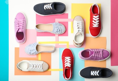 Photo of Flat lay composition with stylish new shoes on color background