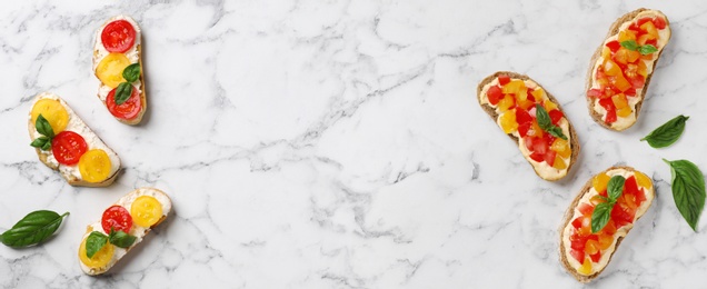 Photo of Tasty fresh tomato bruschettas on marble table, flat lay. Space for text