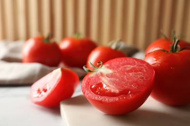 Photo of Fresh ripe tomatoes on white table, closeup