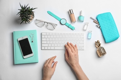 Photo of Blogger with keyboard, smartphone and different accessories on white background, top view
