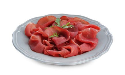Photo of Slices of tasty fresh dry bresaola and arugula isolated on white