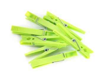 Photo of Bright green plastic clothespins on white background, top view