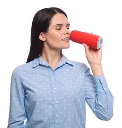 Photo of Beautiful young woman drinking from tin can on white background
