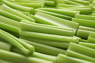 Photo of Fresh green cut celery as background, closeup