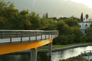 Photo of Bridge in park near mountains at sunset